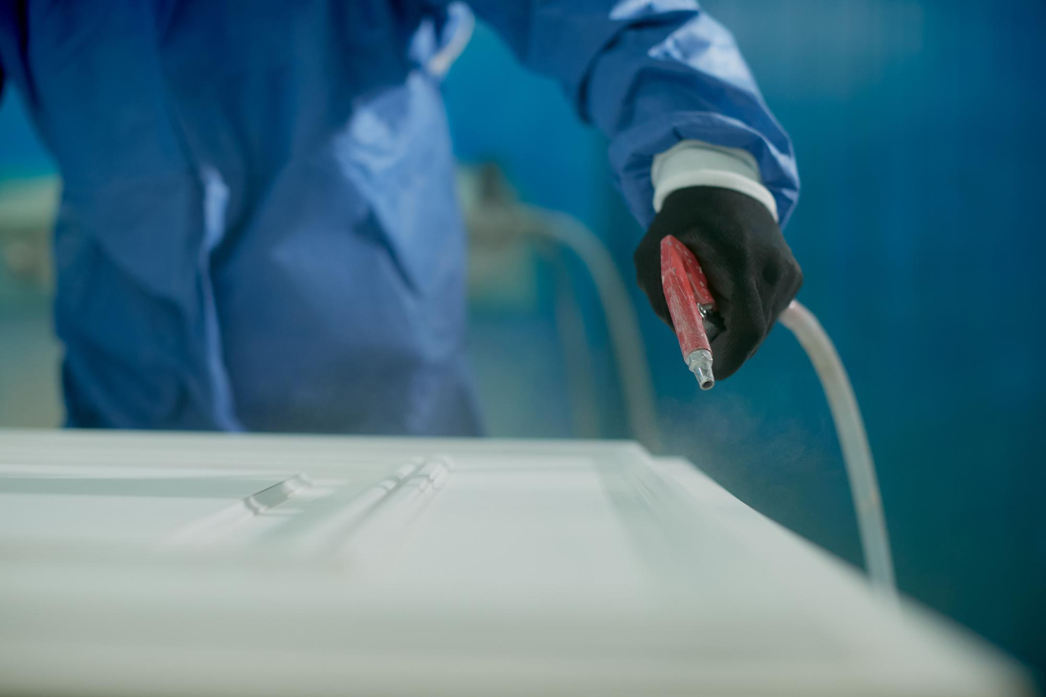 Professional gelcoat spray application on marine surface